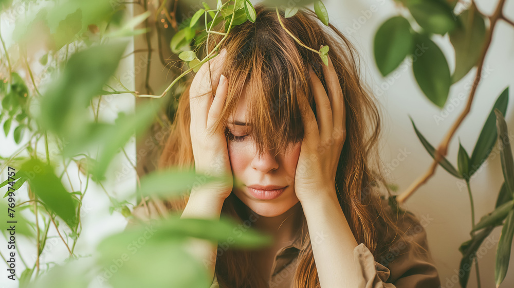 A woman appears overwhelmed or stressed, her hands on her head amidst a vibrant indoor jungle of potted plants. A woman appears overwhelmed or stressed, her hands on her head amidst a vibrant indoor jungle of potted plants.