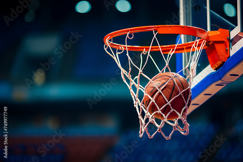 Close-up of a basketball swishing through the net, capturing the decisive moment in a dynamic game © Breyenaiimages