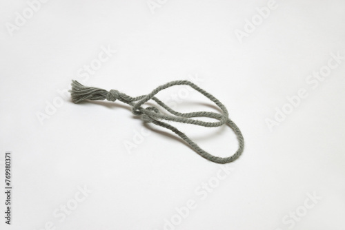 tag rope, gray, tied in a knot. Label tag holder