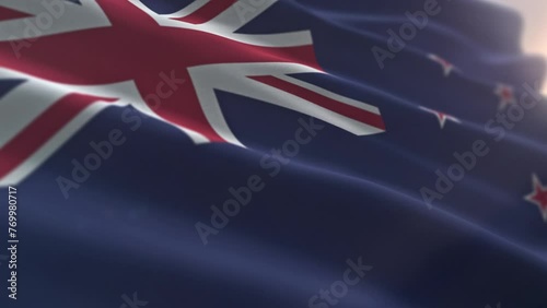 Swinging the official flag symbol of New Zealand. Official flag of the oceanic island country of New Zealand. Official flag of New Zealand with British Union Jack and four red stars. Ensign. photo