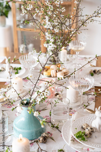 Spring Easter decor. Easter table setting. Flowers and dishes and candles for a festive dinner. High quality 