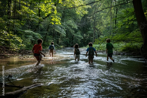 A group of individuals wade through a river in a dense forest setting © Ilia Nesolenyi