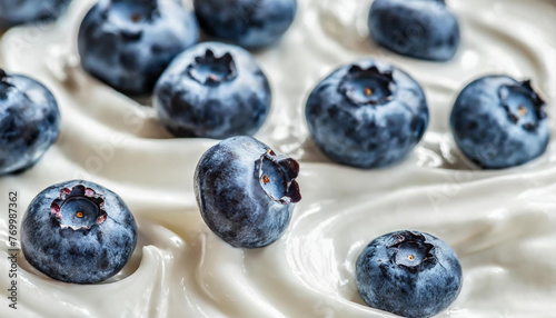 White Greek Yogurt texture. Wave of yogurt with blueberry. Ice cream background. Tasty liquid texture of sour cream with berry. Creamy dairy product.