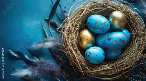 Nest with golden eggs on blue wooden table, top view. Space for text. Easter holiday celebration banner greeting card - Blue and golden painted easter eggs in birds nest on bright blue backround tabel