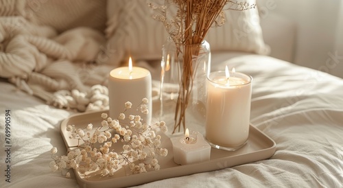 Cozy home interior with candles and dried flowers in vase on tray