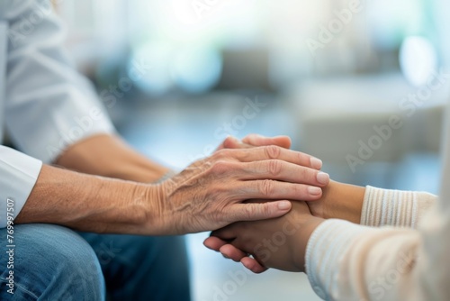 Compassionate healthcare professional holding a patient's hands in a comforting gesture at a medical facility Concept: healthcare, support, medical care