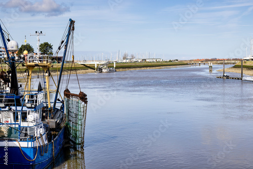a fishing boat on the quay in Nieuwpoort with a view of the River the Yser