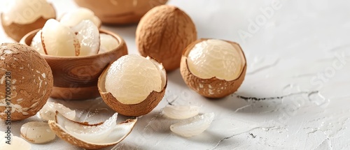  A cluster of nuts resting together on a white table with shells and peels