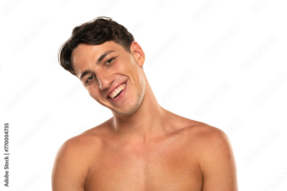 Closeup portrait of happy shirtless man 20s looking at camera isolated over white studio background Closeup portrait of happy shirtless man 20s looking at camera isolated over white studio background