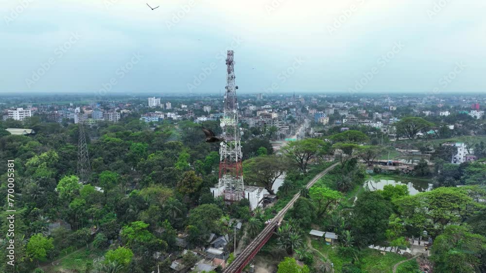 Technician climbing a network tower to fix it. Skilled work that technicians do to keep our communication networks running smoothly Technician climbing a network tower to fix it. Skilled work that technicians do to keep our communication networks running smoothly