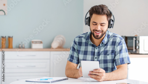 Young man using tablet computer for online learning at home
