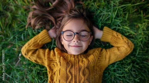 Young Boy With Glasses Laying on Grass