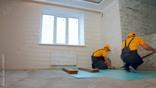 Thermal insulation of the floor in the apartment. Builders insulated floor in a large house. © DenisProduction.com