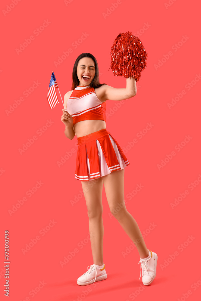 Female cheerleader with USA flag on red background Female cheerleader with USA flag on red background