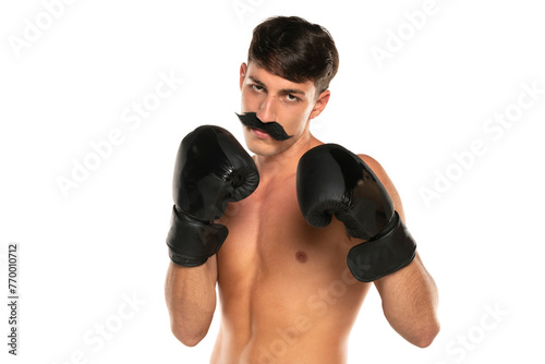 Young shirtless man with moustache and boxing gloves on a white background