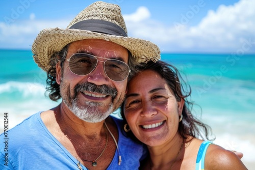 Smiling portrait of a middle aged hispanic couple on vacation at the beach