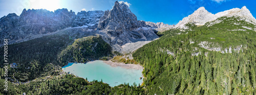 Lake Sorapis in the Dolomites Italy - Aerial view of beautiful mountains lake with snow capped peaks in the background
