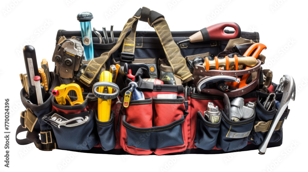 A tool bag overflowing with various tools, spilling out onto a workbench