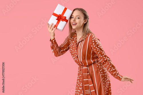 Happy young woman holding w...