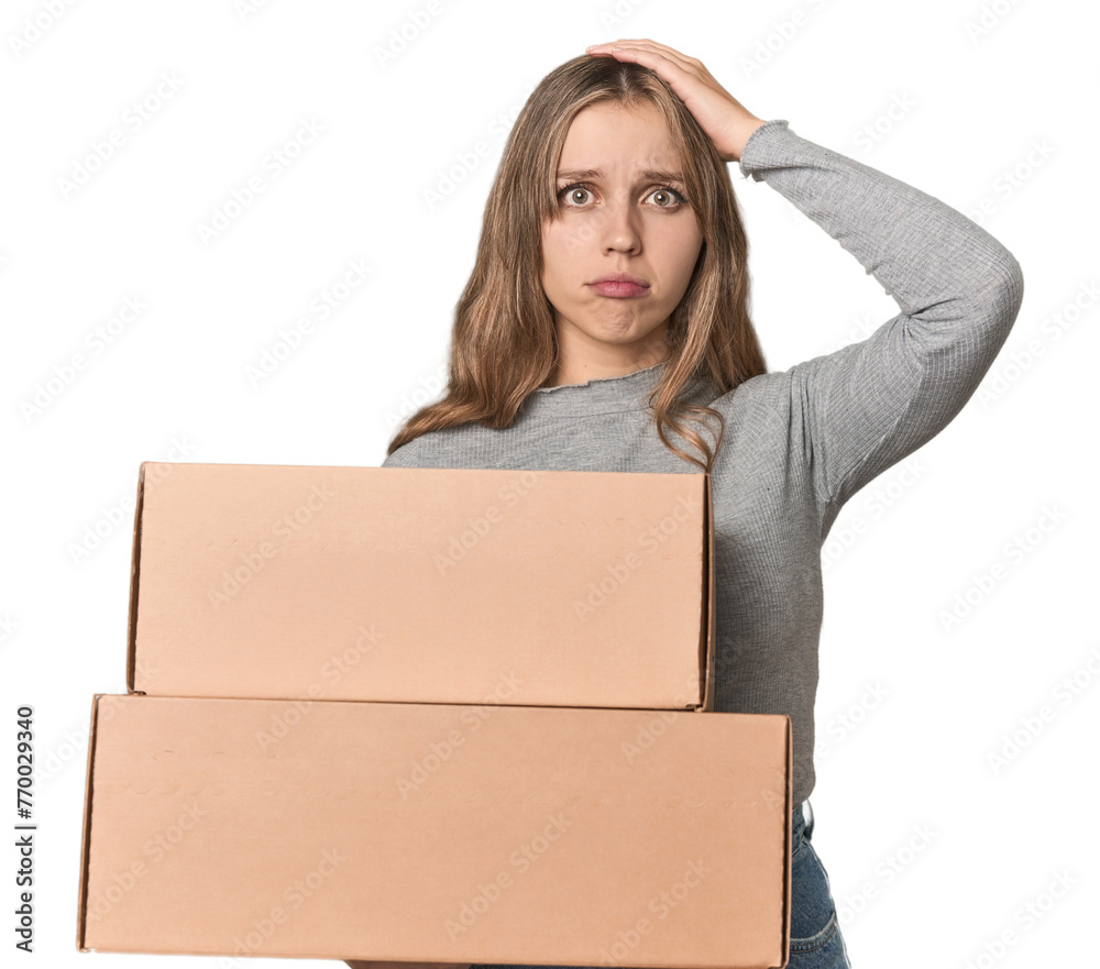 Blonde woman with cardboard boxes moving on studio backdrop being shocked, she has remembered important meeting. Blonde woman with cardboard boxes moving on studio backdrop being shocked, she has remembered important meeting.