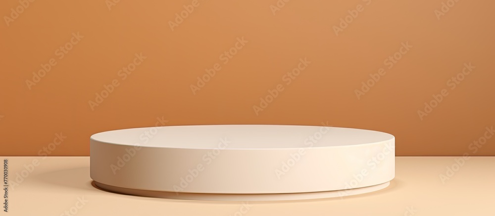 A white porcelain podium is displayed on a table in front of a brown wall, surrounded by various kitchen utensils and tableware