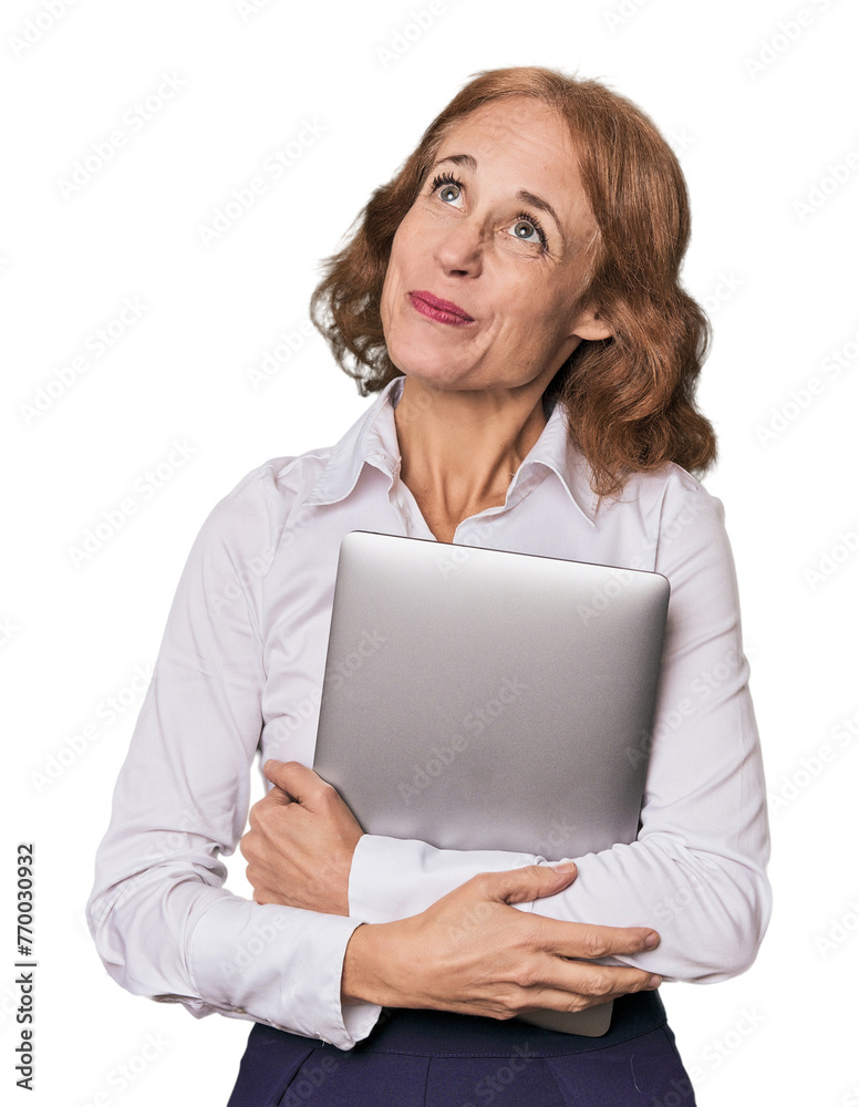 Mid-aged Caucasian with laptop in studio dreaming of achieving goals and purposes Mid-aged Caucasian with laptop in studio dreaming of achieving goals and purposes
