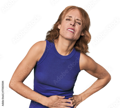 Redhead mid-aged Caucasian woman in studio having a liver pain, stomach ache.