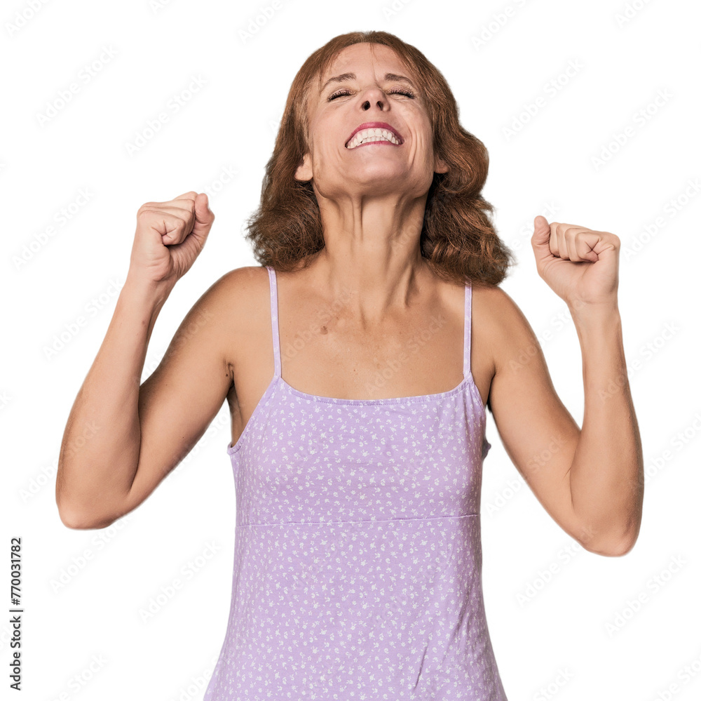 Redhead mid-aged Caucasian woman in studio celebrating a victory, passion and enthusiasm, happy expression. Redhead mid-aged Caucasian woman in studio celebrating a victory, passion and enthusiasm, happy expression.