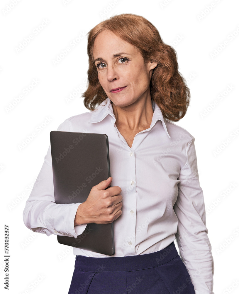 Elegant middle-aged woman confidently working with laptop in studio Elegant middle-aged woman confidently working with laptop in studio