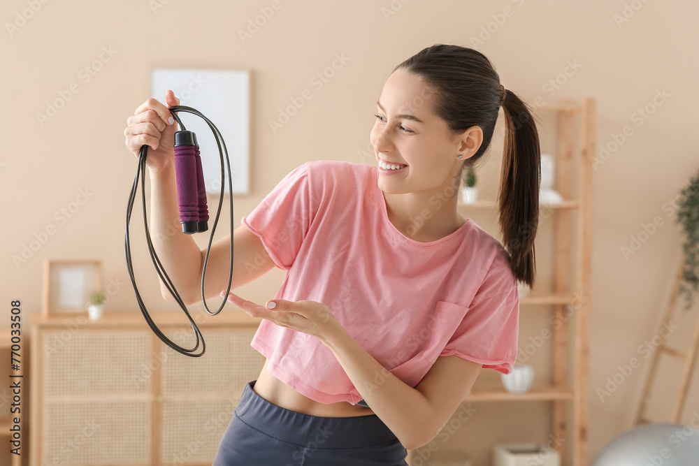 Sporty female blogger with skipping rope at home - obrazy, fototapety, plakaty 
