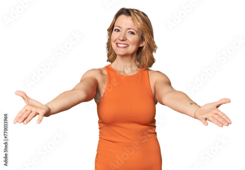 Blonde middle-aged Caucasian woman in studio showing a welcome expression.