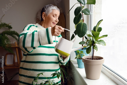 Senior gardener watering pl...