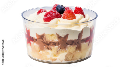 A decadent dessert served in a glass bowl, topped with vibrant fresh fruit