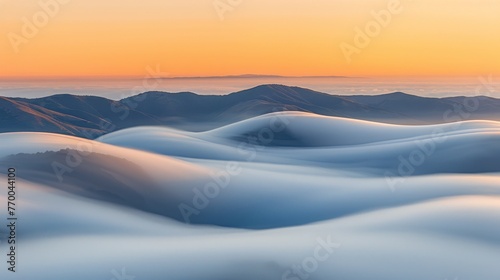  A panoramic photo of distant mountains viewed from above the clouds
