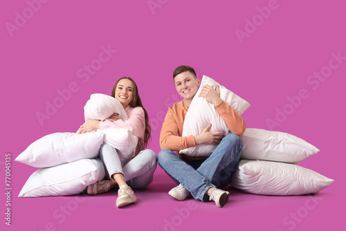 Young couple with pillows s...
