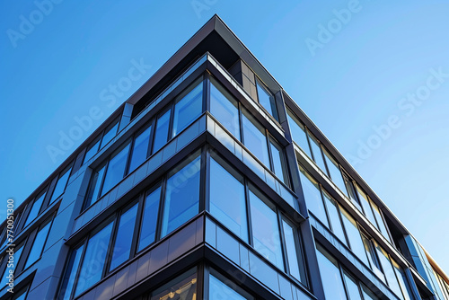 Facade of sleek  contemporary European apartment building  showcasing innovative use of glass and metal materials under clear blue sky.