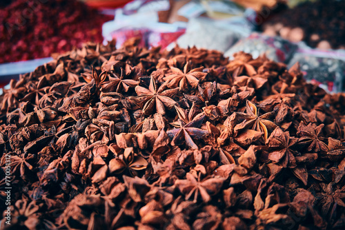 Chinese badian star. Illicium verum. Heap of star anise spices at bazaar stall