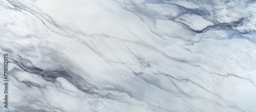 A detailed shot of a white marble texture, resembling the snowy slope of an ice cap. The geological phenomenon displays freezing patterns similar to cumulus clouds, creating a winter landscape © TheWaterMeloonProjec