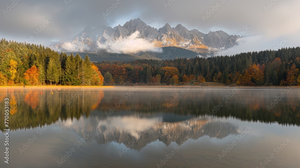 A serene lake enveloped by lush foliage, framed by majestic mountains and adorned with fluffy clouds above, with scattered trees in the foreground A serene lake enveloped by lush foliage, framed by majestic mountains and adorned with fluffy clouds above, with scattered trees in the foreground