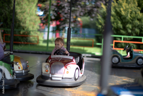 The Joyous Ride, A Whimsical Encounter of a Little Boy Cruising a Bumper Car at the Vibrant Park