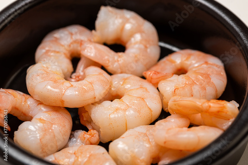 shrimps in a pan,Peeled shrimps in a bowl  © Anna Kondratiuk
