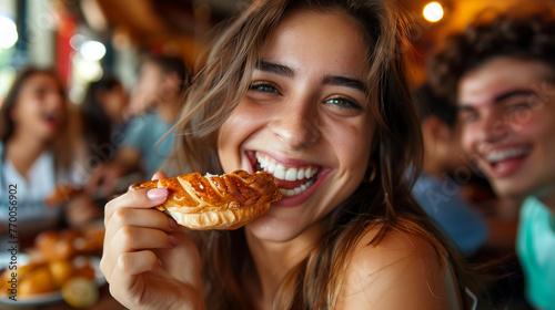 Young Latina woman eating an empanada.