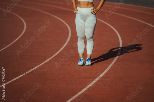 Sportswoman's legs standing on running track on stadium. © Zamrznuti tonovi