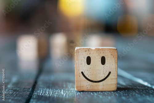 Smiling emoticon is drawn on the wooden cube, symbolizing the joy of working in team.