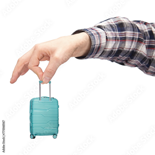 luggage and hand luggage, a miniature mint-colored suitcase on a white isolated background in the hand, the concept of a limit on the weight of baggage carried in airlines