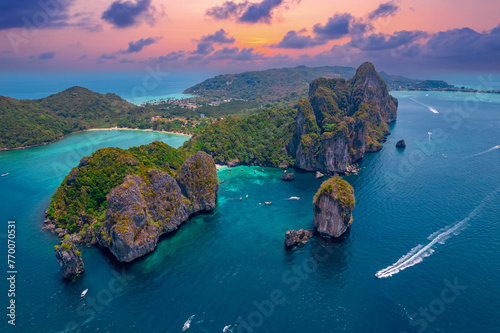Landscape koh Phi Phi Don island, Krabi, Thailand. Aerial view paradise Nui beach, turquoise lagoon with white coral sand and palms on sunset time.