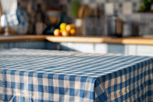 Cozy kitchen interior with a focus on a blue and white checkered tablecloth on a table, blurred background with wooden countertops and fresh fruit. High quality photo photo