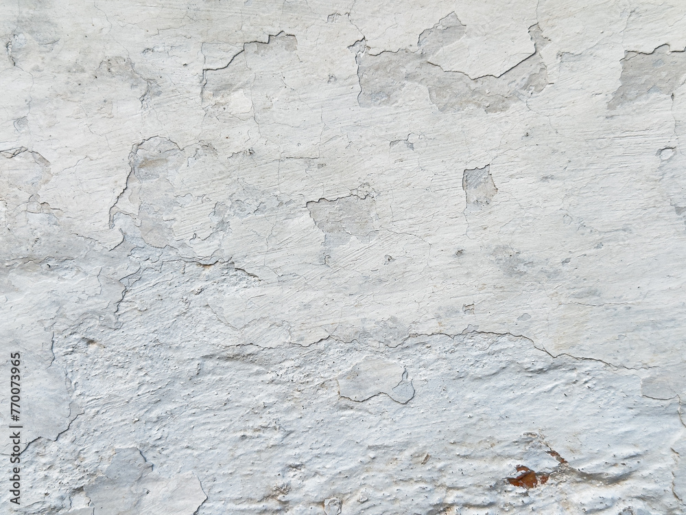 Close-up of a white wall with cracked paint