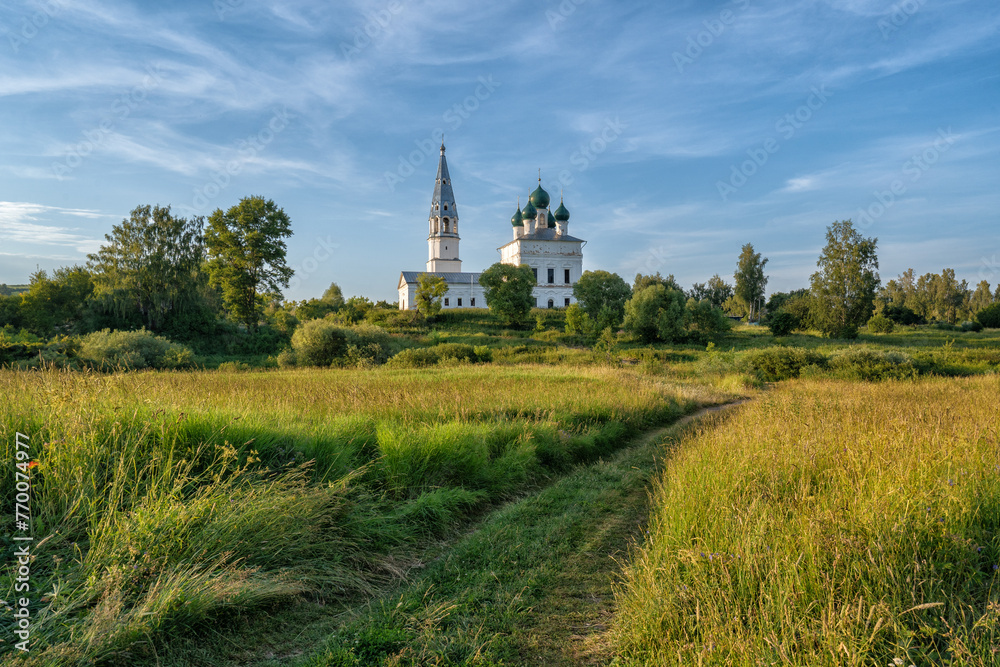 Φωτογραφία Rustic landscape, road through the field, ahead of the church in the village of Osenevo, Russia