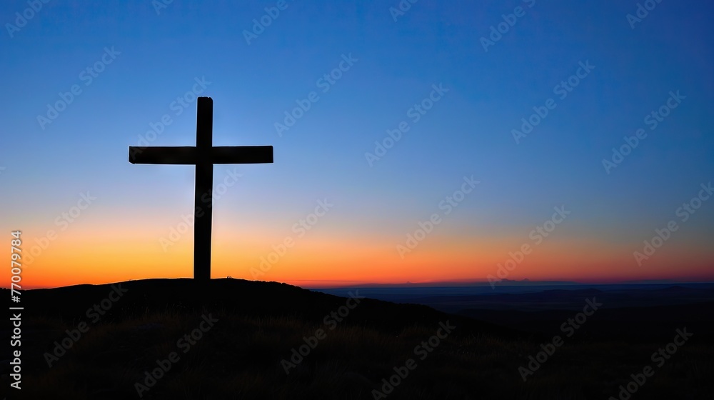 A powerful photograph of a cross silhouetted against a clear blue sky, conveying the significance of the cross in the Christian faith and the promise of redemption